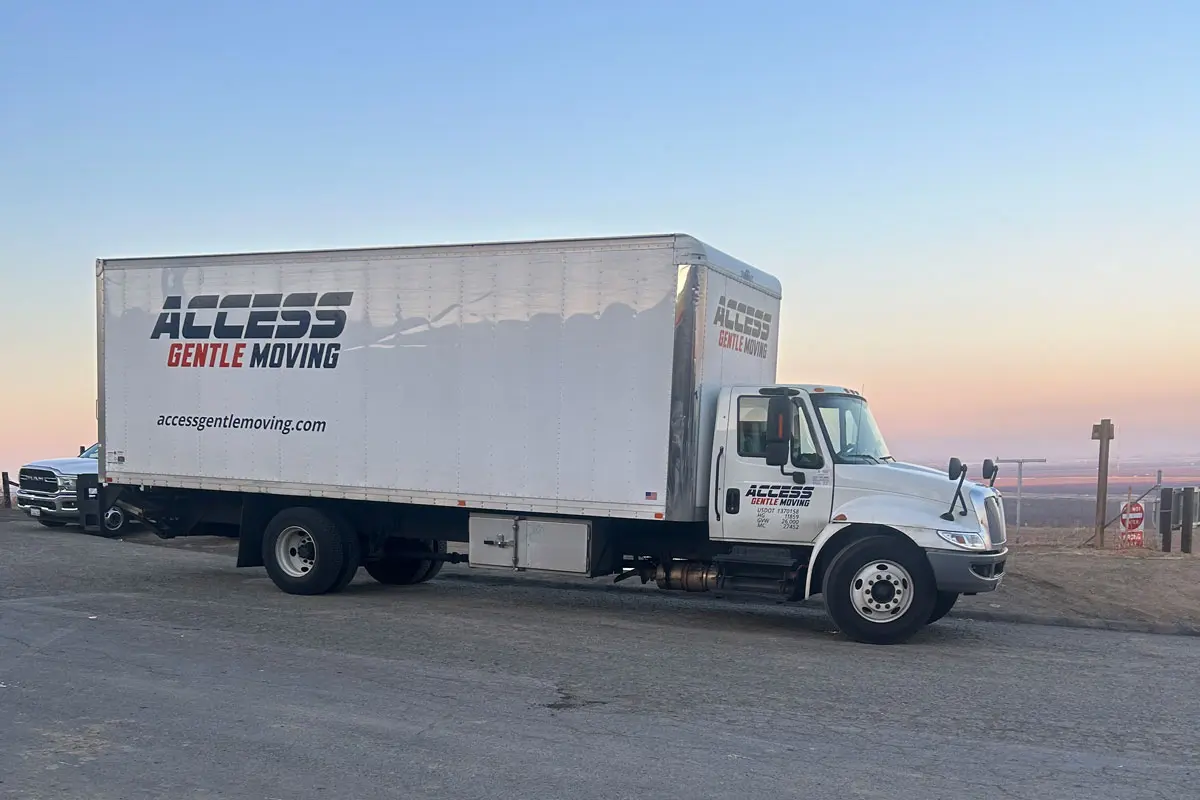 Access Gentle Moving truck parked at sunset